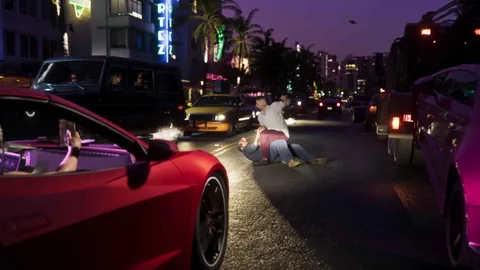Une décapotable rouge arrêtée dans une rue de Vice City de nuit, devant une bagarre, photogramme de l’Extended Look