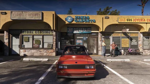 Voiture rouge rapprochée d’une Sentinel Classic devant une station-service, visuel officiel Rockstar Games
